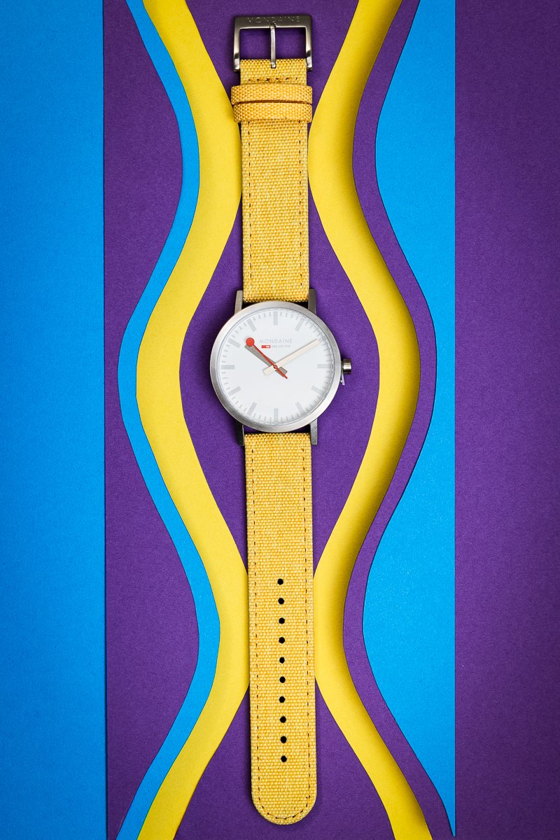 High-end commercial product photography of a yellow watch